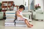 Litlle girl reading lot of books