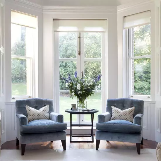 French windows with blue velvet chairs