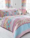beautiful-warm-colorful-shabby-chic-bedroom-design-in-lovely-white-pink-and-blue-color-shades-with-awesome-floral-patterns-on-bed-cover-pillows-and-window-curtains-interior-design-styles-uniquely