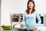 Woman pouring tap water