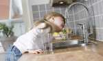 child-girl-is-drinking-tap-water-in-kitchen-at-home